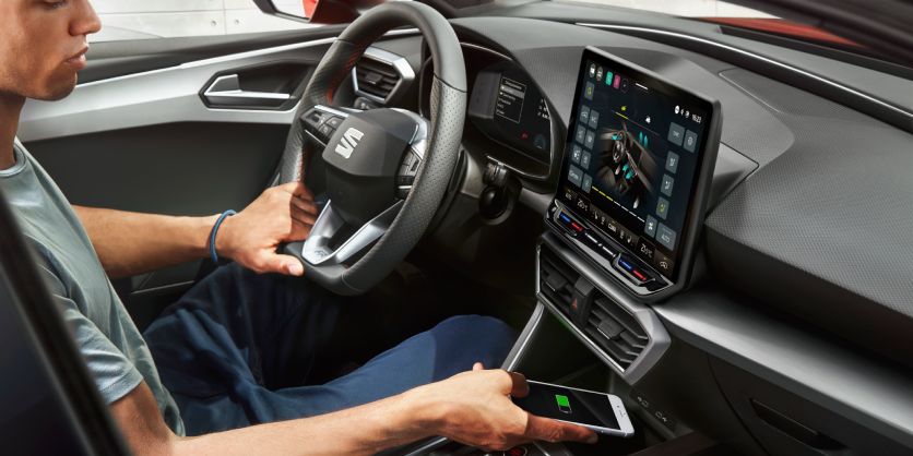 Hombre sentado en el interior de un SEAT sujetando el volante