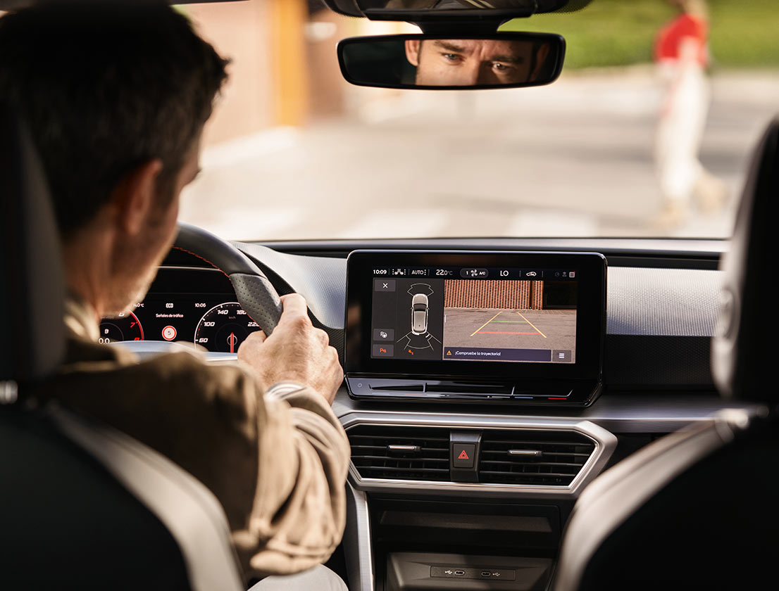 man-using-park-assist-rear-view-camera