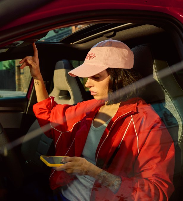 Chica contactando con el servicio de asistencia en carretera mediante el botón de asistencia integrado en su SEAT Ibiza