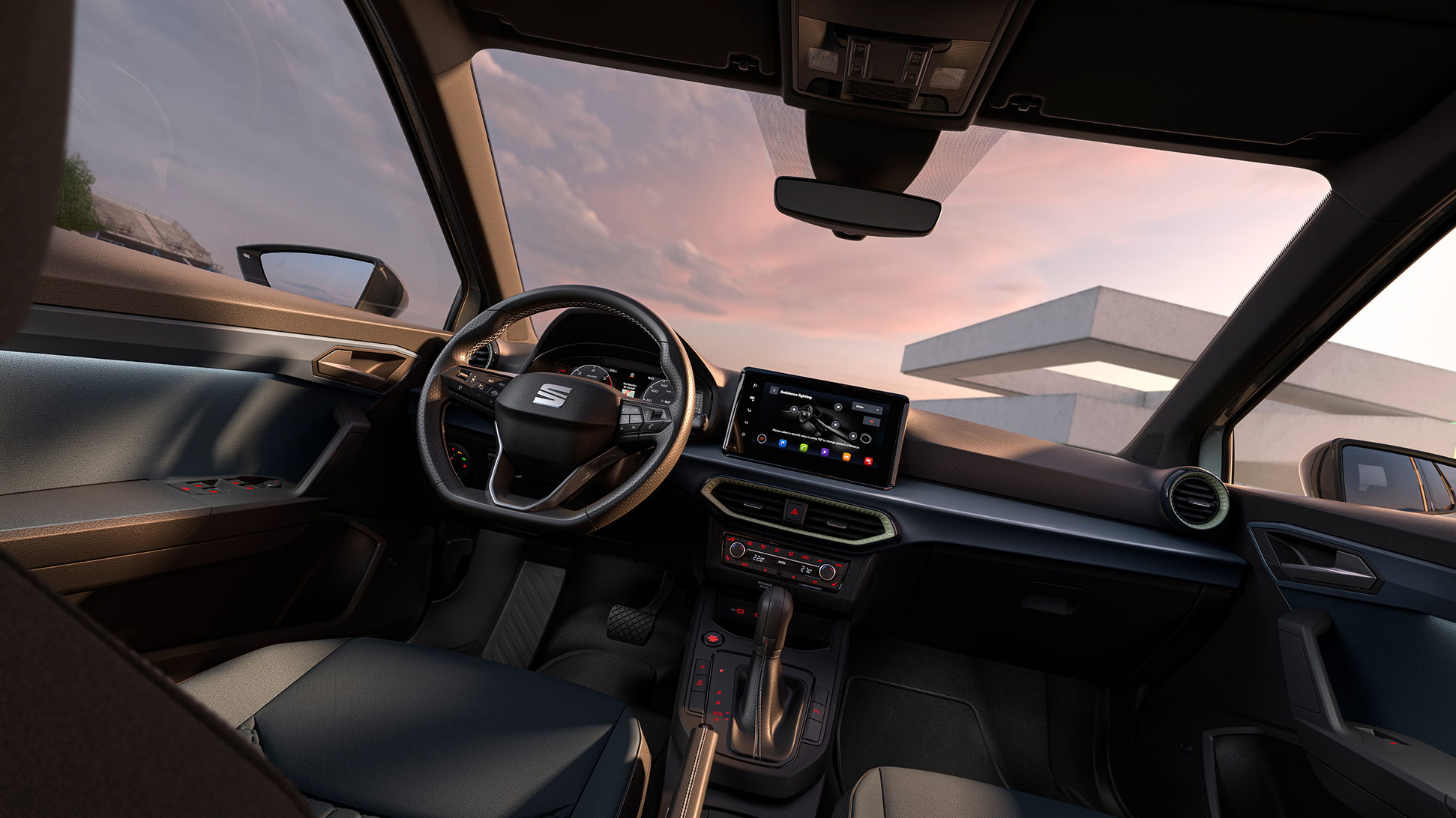 Detalles del interior del SEAT Arona, como parte de la tapicería, la pantalla táctil o el volante.