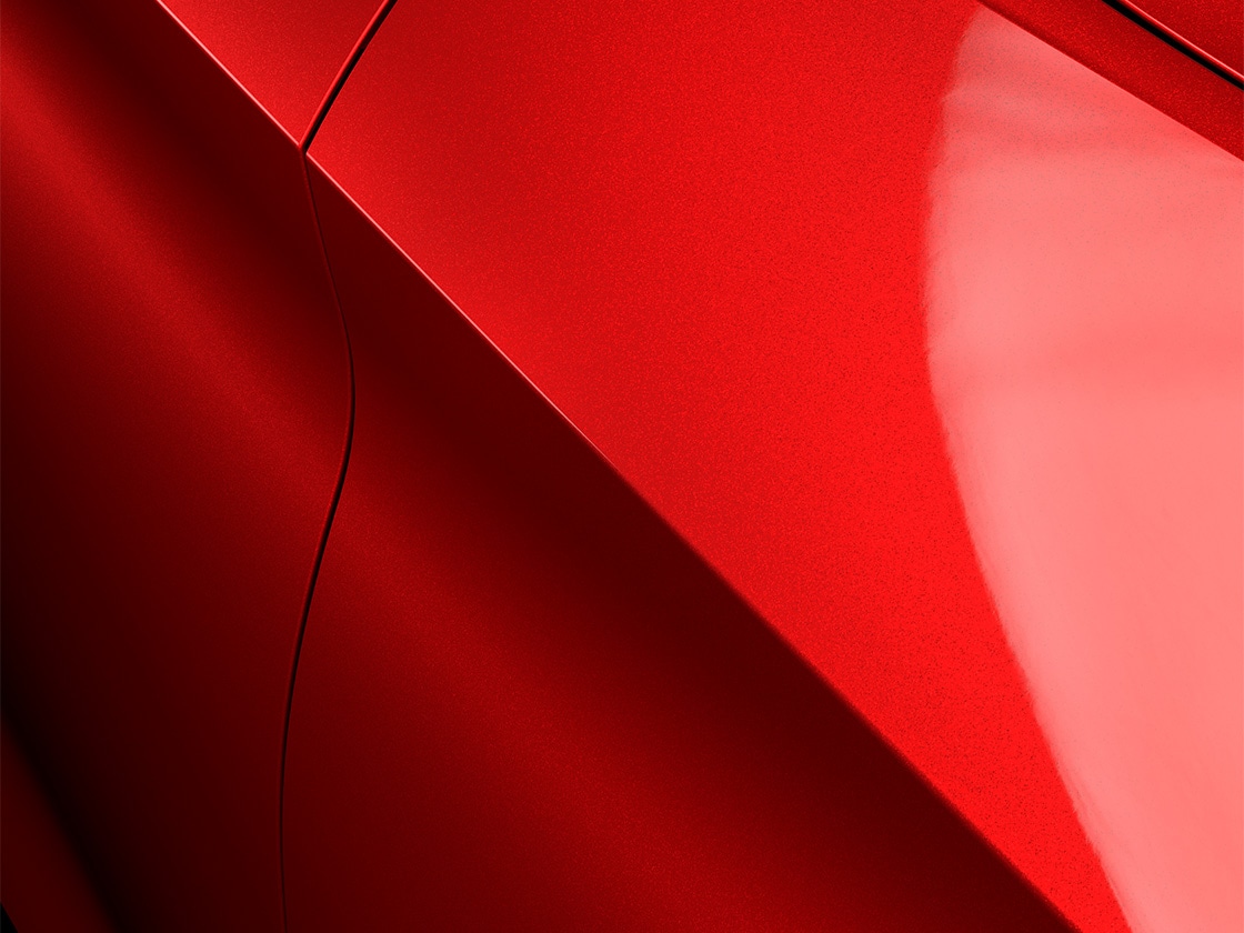 Seat León Sportstourer FR en rojo Desire con un acabado especial metalizado, primer plano.