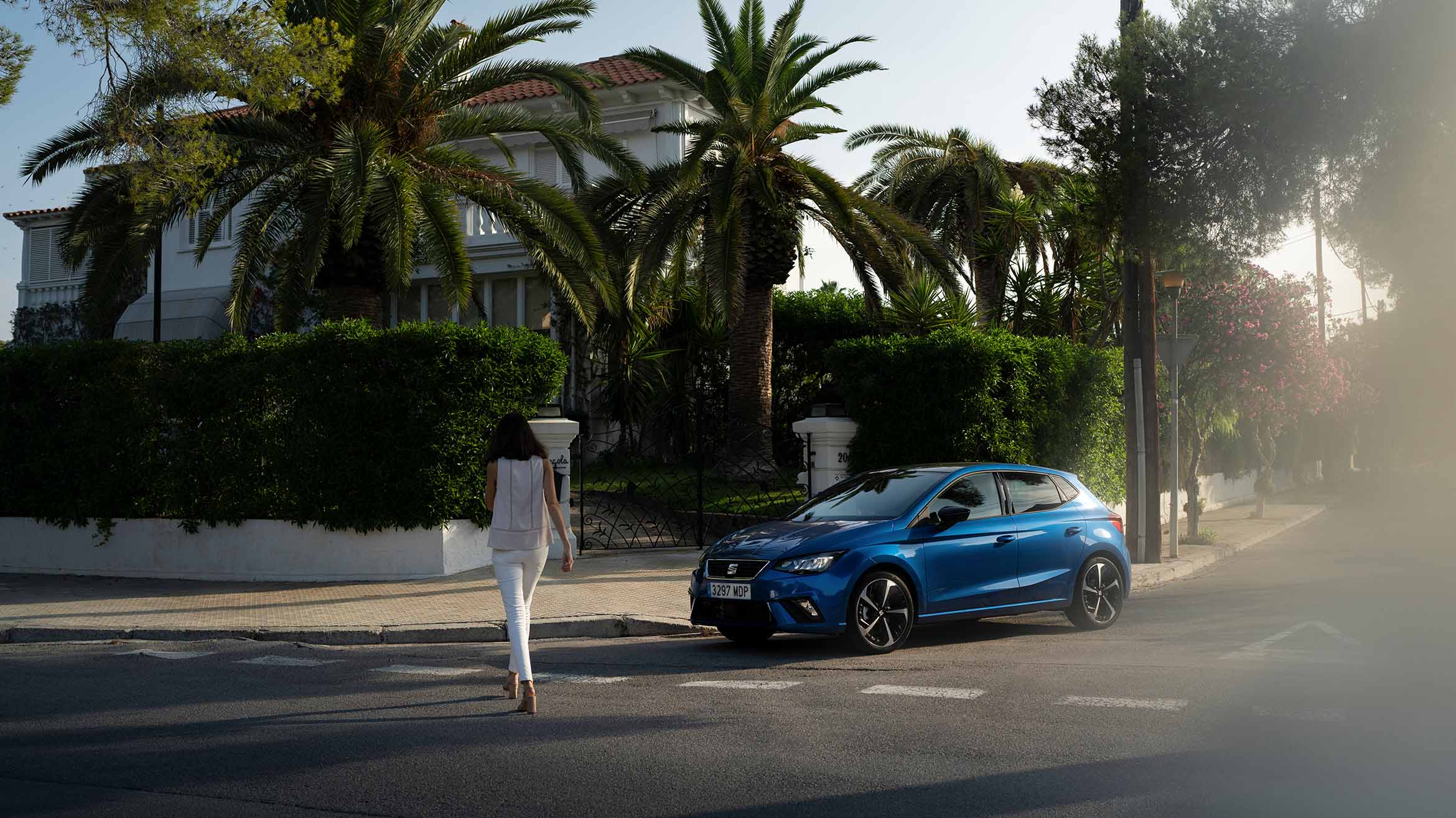 Mujer caminando junto al SEAT Ibiza