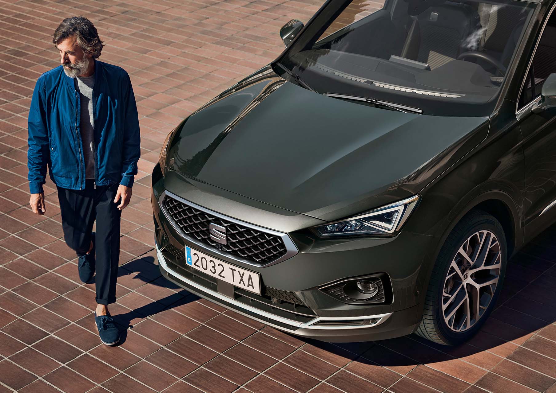 Hombre delante del nuevo SEAT Tarraco XPERIENCE con llantas de aleación