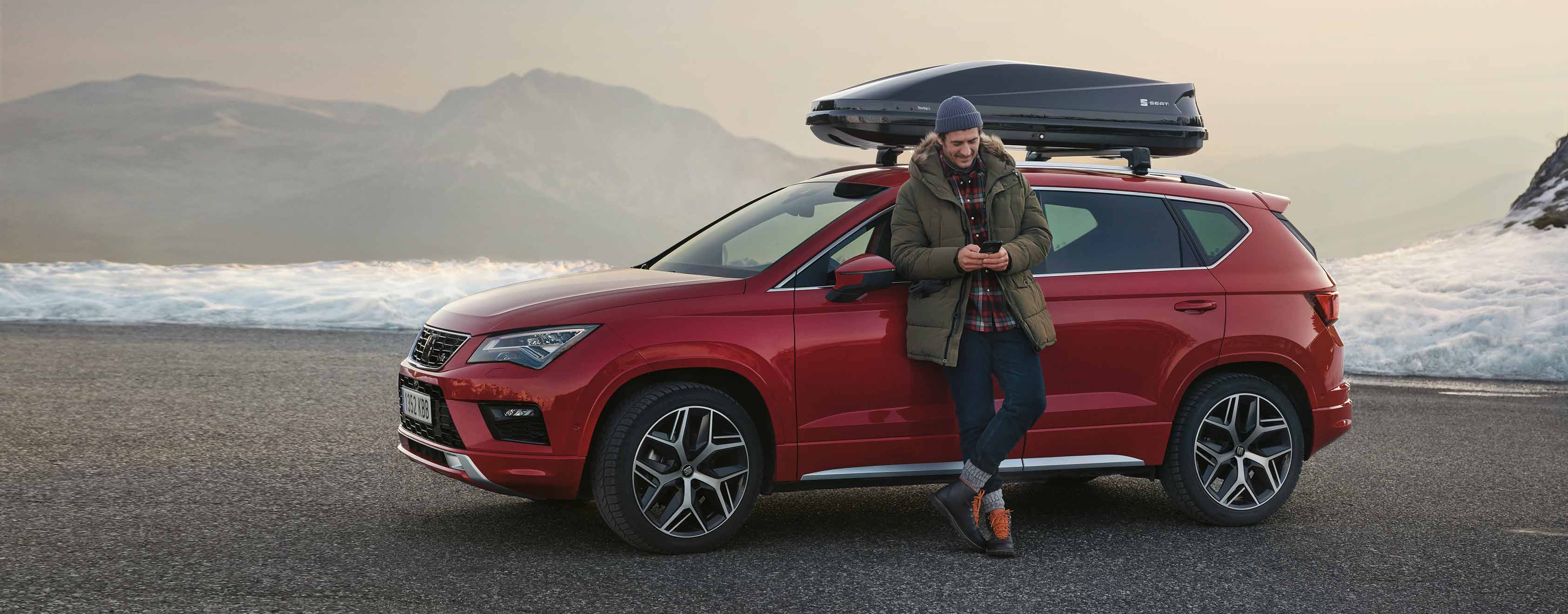 man-standing-with-his-phone-in-a-seat-ateca